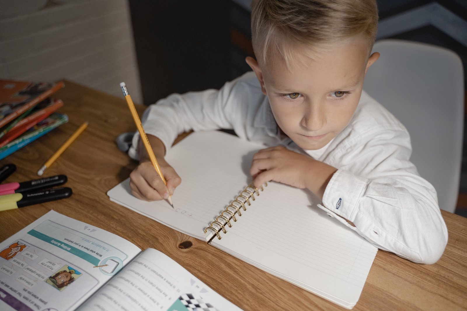 Primary-age pupil completing written work during 11+ preparation